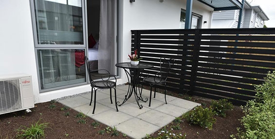each ground floor unit has private patio with outdoor seating